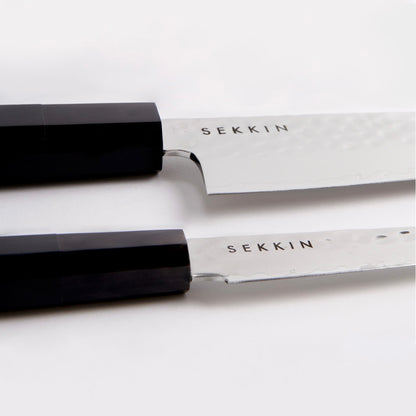 Two SEKKNIN knives with black handles on a white background