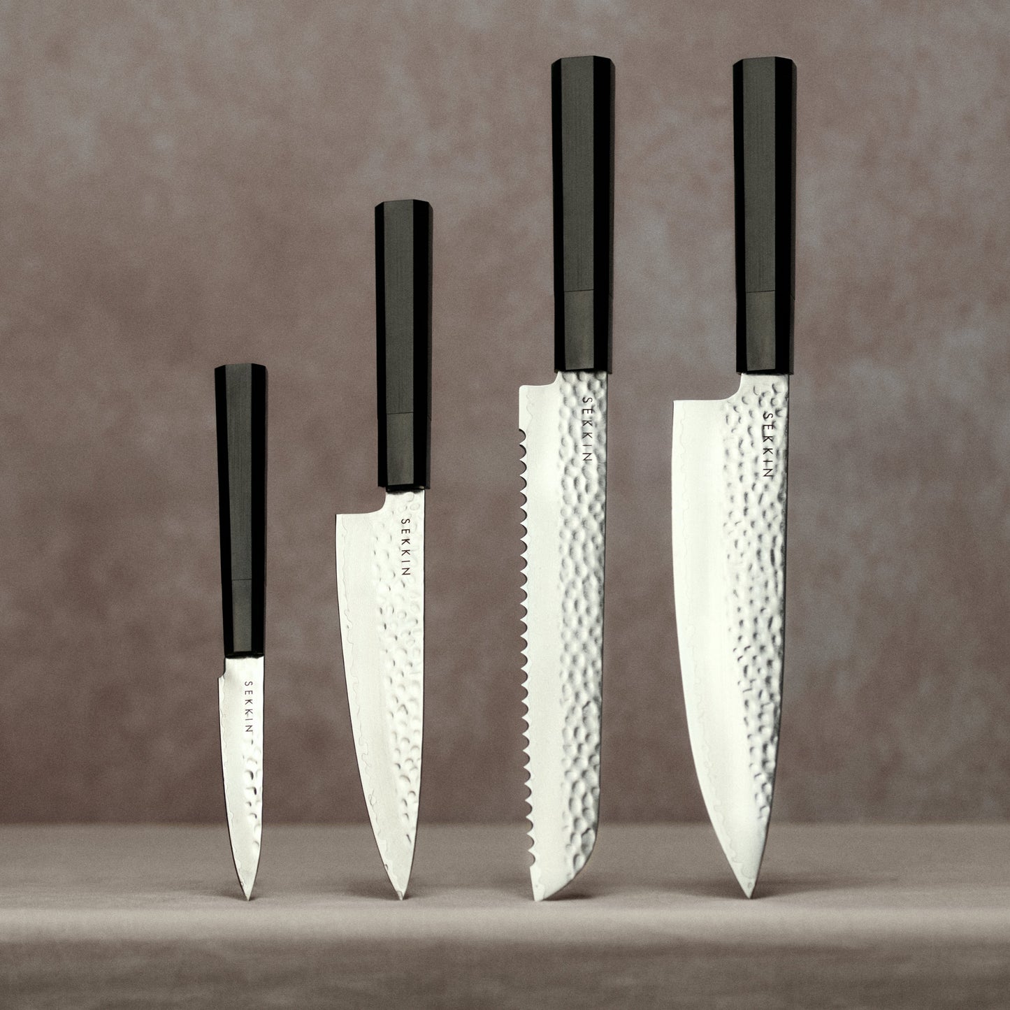 Full knife set on pink background
