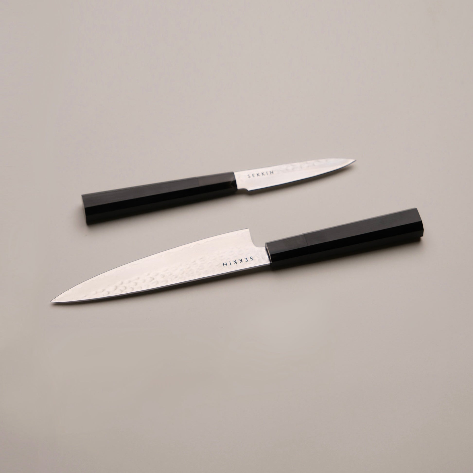 Two SEKKIN Knives on a white surface